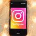Cellulare con logo Instagram su fondo beige