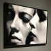 Fotografia in bn appesa a un muro con due visi femminili - Mostra su Helmut Newton alla Gam di Torino