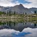 Cielo, montagne e rive che si specchiano nel Lago di Afframont in Val d'Ala
